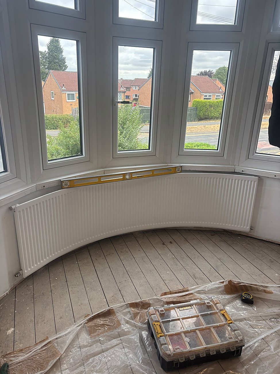Curved radiator fitted to a bay window by Rapid Plumbing and Build in Sheffield